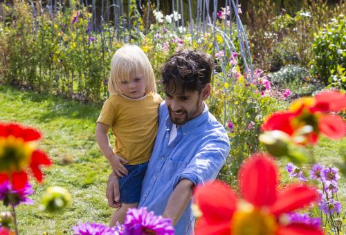 Father and child looking at flowers